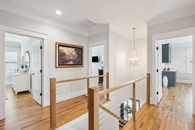 3858 Sawyers Island Dr, Mount Pleasant, SC 29466 - hall with crown molding, an upstairs landing, light wood-style flooring, visible vents, and an inviting chandelier