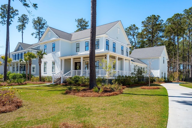 3858 Sawyers Island Dr, Mount Pleasant, SC 29466 - modern inspired farmhouse with a front lawn, board and batten siding, and a porch