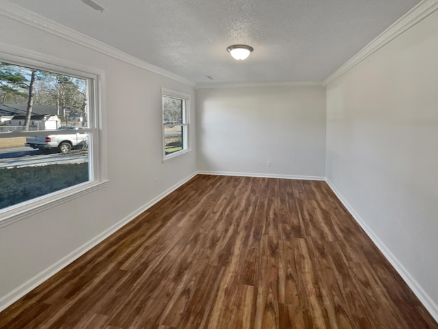 spare room featuring a textured ceiling, crown molding, and dark wood-type flooring