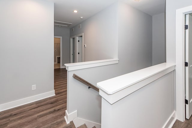 hall with visible vents, an upstairs landing, dark wood-style floors, recessed lighting, and baseboards