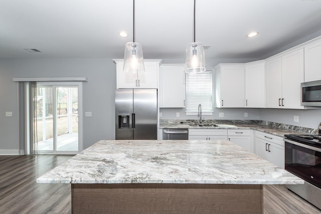 kitchen with a sink, white cabinets, and stainless steel appliances