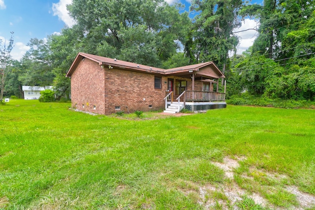 exterior space featuring covered porch and a yard