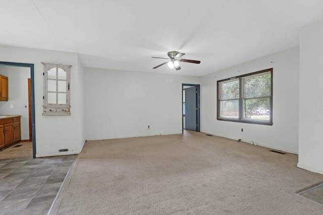 carpeted empty room with ceiling fan