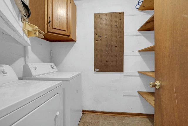 laundry area with washer and clothes dryer and cabinets