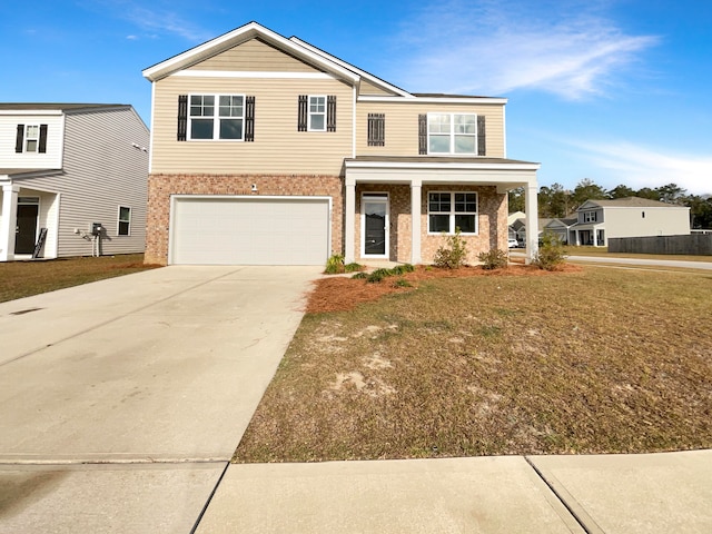 view of front of house featuring covered porch, a garage, and a front lawn