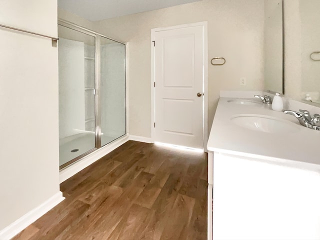 bathroom with vanity, hardwood / wood-style flooring, and walk in shower