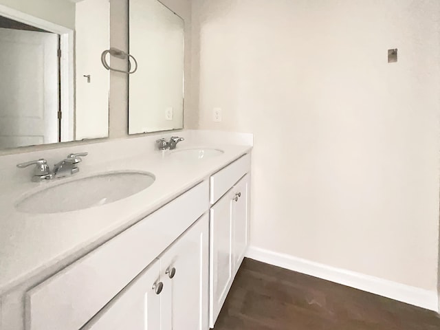 bathroom with hardwood / wood-style floors and vanity