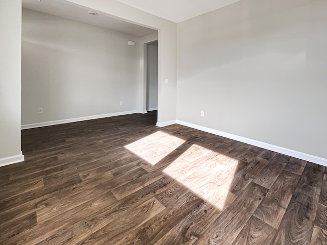 empty room with dark wood-type flooring