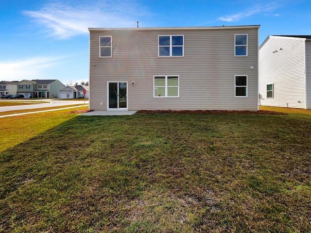 rear view of property with a patio and a lawn