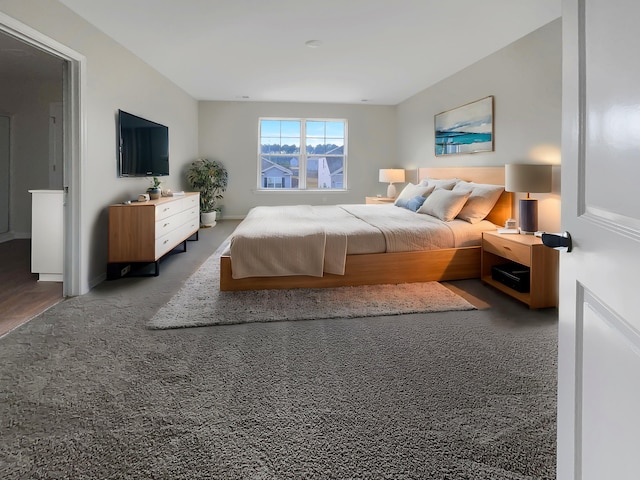 bedroom with dark colored carpet