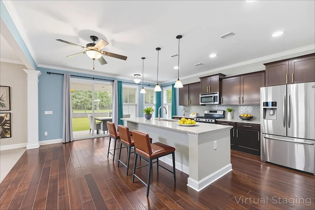 158 Netherfield Dr, Summerville, SC 29486 - kitchen featuring stainless steel appliances, crown molding, a breakfast bar, ceiling fan, and a kitchen island with sink