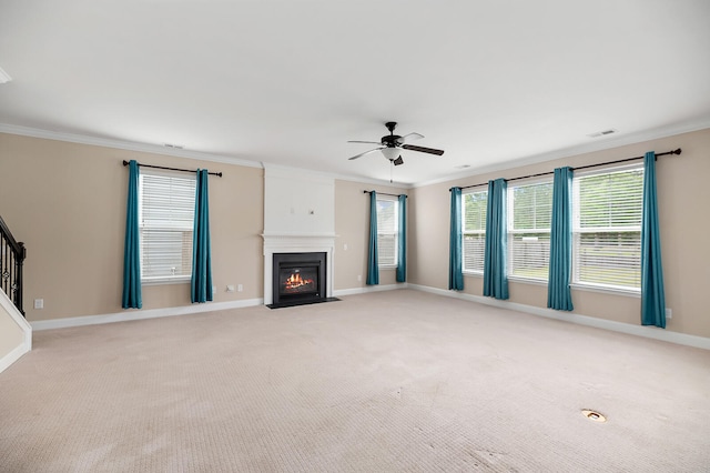 158 Netherfield Dr, Summerville, SC 29486 - unfurnished living room with crown molding, ceiling fan, a fireplace with flush hearth, light colored carpet, and stairs