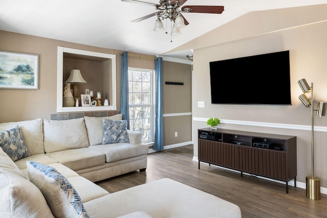 living area featuring vaulted ceiling, wood finished floors, a ceiling fan, and baseboards