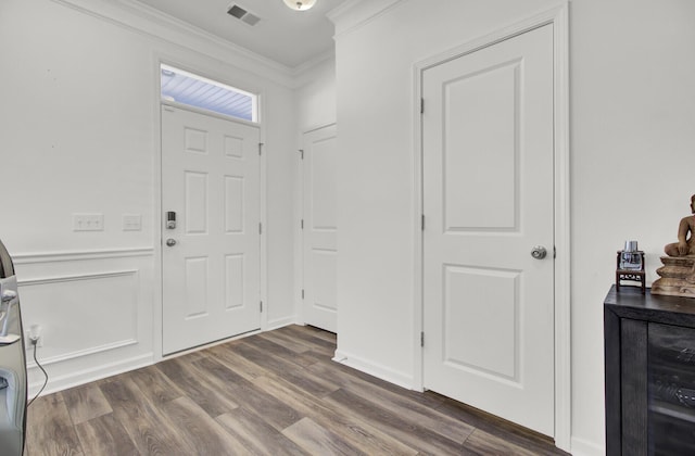 entryway with ornamental molding, dark hardwood / wood-style floors, and wine cooler