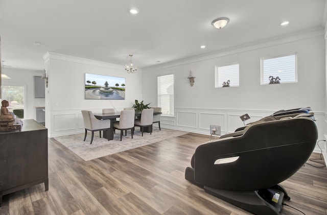 dining room with ornamental molding, a wealth of natural light, a chandelier, and hardwood / wood-style flooring