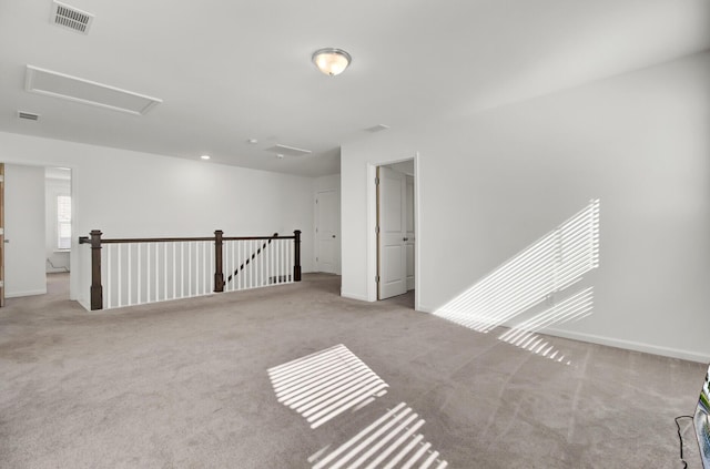 unfurnished room featuring light carpet