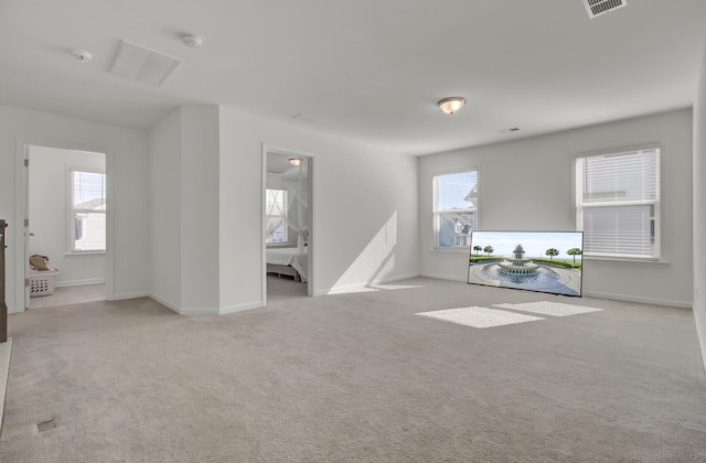 unfurnished living room with light colored carpet