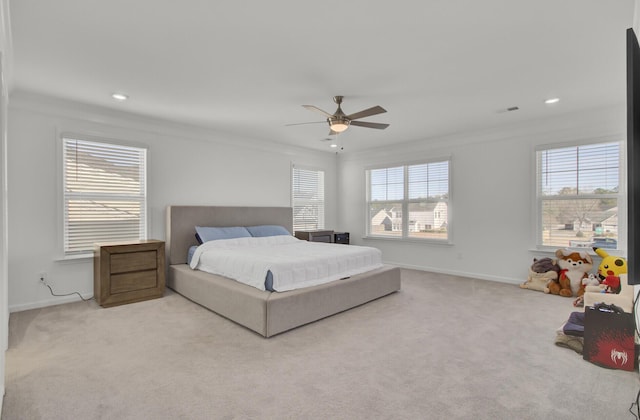 bedroom featuring ceiling fan, crown molding, light carpet, and multiple windows