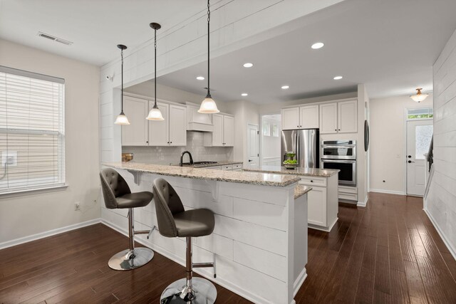 1870 Gammon St, Charleston, SC 29414 - kitchen with appliances with stainless steel finishes, a peninsula, white cabinetry, baseboards, and recessed lighting