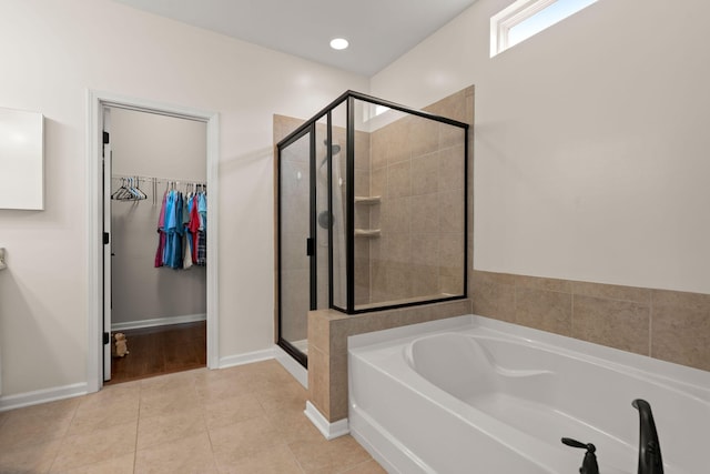 1870 Gammon St, Charleston, SC 29414 - bathroom with a stall shower, a bath, a walk in closet, tile patterned flooring, and baseboards