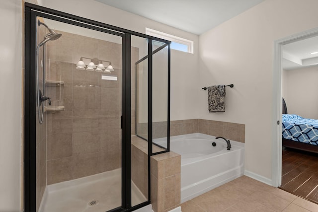1870 Gammon St, Charleston, SC 29414 - ensuite bathroom featuring a shower stall, a garden tub, tile patterned flooring, and baseboards