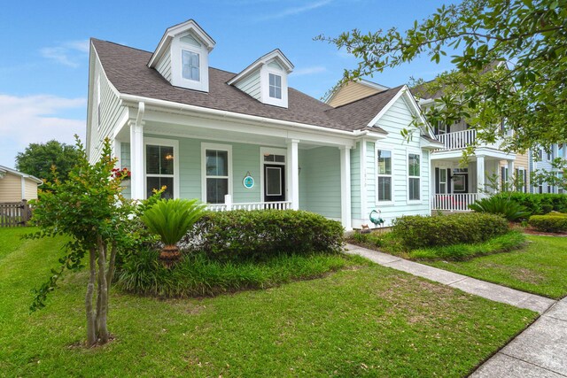 1870 Gammon St, Charleston, SC 29414 - view of front of house with a porch, a front yard, and roof with shingles