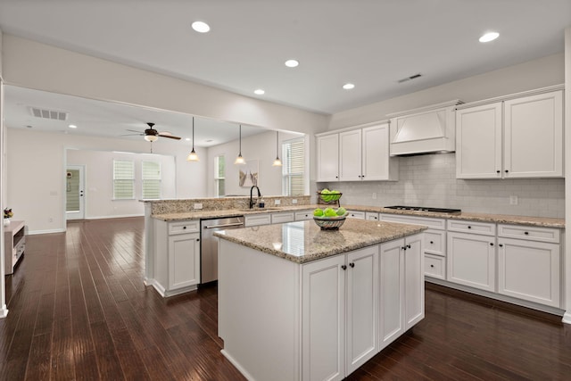 1870 Gammon St, Charleston, SC 29414 - kitchen with appliances with stainless steel finishes, custom exhaust hood, a peninsula, a sink, and white cabinetry