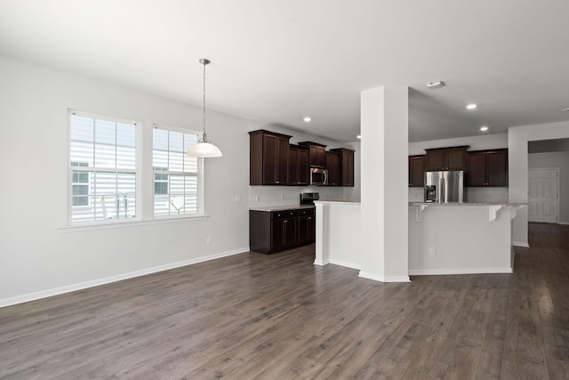 341 Witch Hazel St, Summerville, SC 29486 - kitchen featuring appliances with stainless steel finishes, dark wood-style floors, a breakfast bar area, dark brown cabinets, and recessed lighting