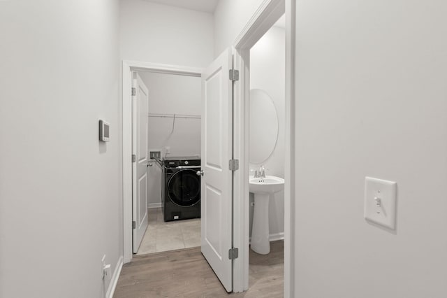 341 Witch Hazel St, Summerville, SC 29486 - hall featuring washer / clothes dryer, light wood-type flooring, baseboards, and a sink
