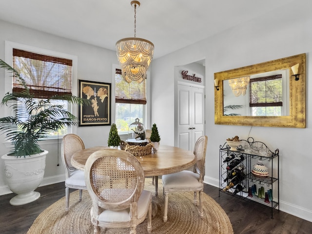 dining space with dark wood-style floors, baseboards, and an inviting chandelier