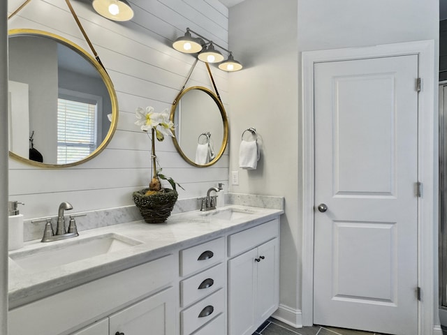 full bath with a sink and double vanity