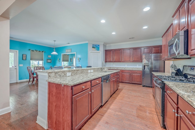 kitchen featuring stainless steel appliances, light hardwood / wood-style floors, decorative light fixtures, and crown molding