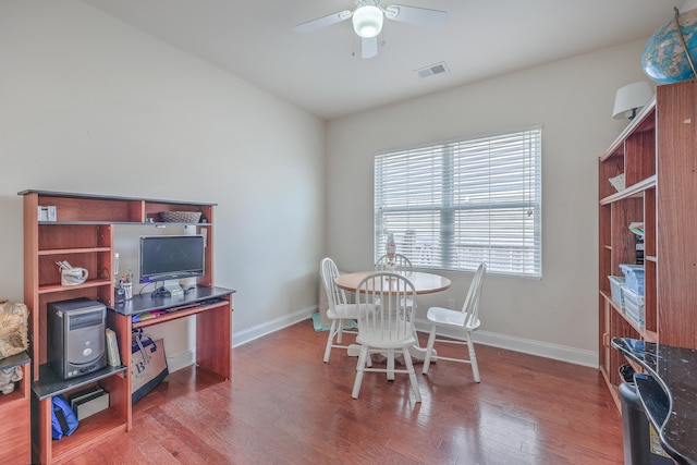 dining space with wood-type flooring and ceiling fan