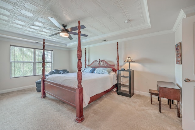 bedroom with light carpet, a tray ceiling, ceiling fan, and crown molding