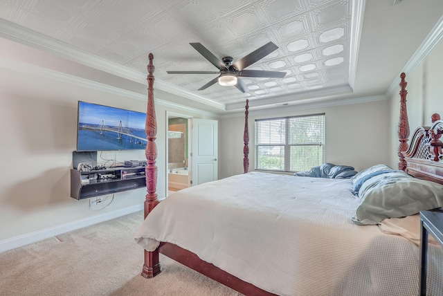 bedroom with ceiling fan, a tray ceiling, ornamental molding, and carpet