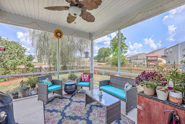 sunroom with ceiling fan and wooden ceiling