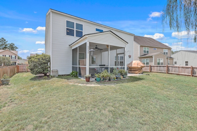 back of house with a lawn and ceiling fan