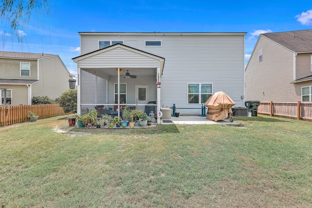 back of house featuring ceiling fan, cooling unit, a yard, and a patio