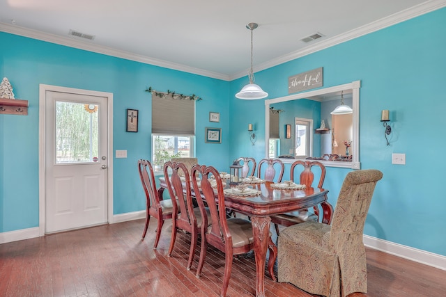 dining space with ornamental molding and wood-type flooring