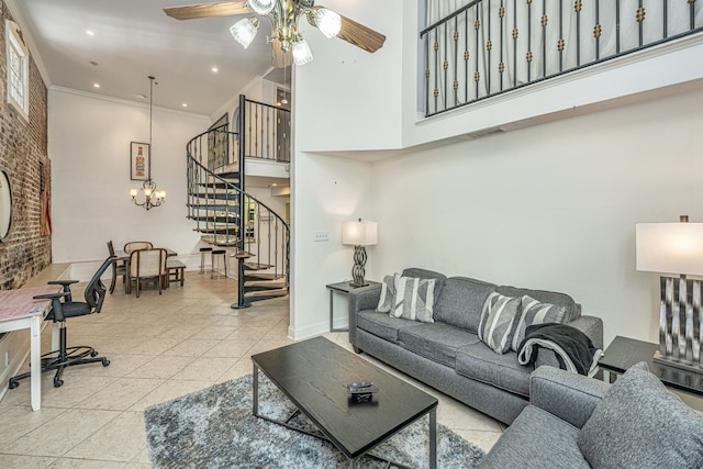 living room featuring light tile patterned flooring, ceiling fan with notable chandelier, ornamental molding, and a high ceiling