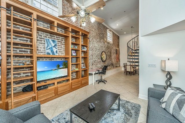 living room with ornamental molding, ceiling fan, brick wall, and light tile patterned floors