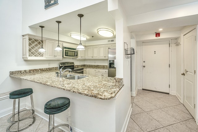 kitchen featuring kitchen peninsula, appliances with stainless steel finishes, hanging light fixtures, and sink