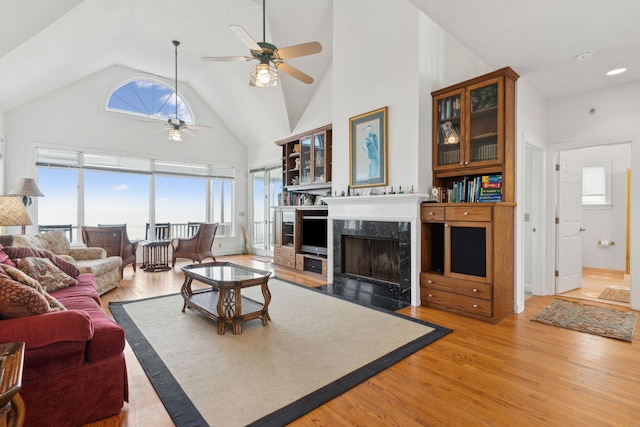 505 E Arctic Ave, Folly Beach, SC 29439 - living area featuring ceiling fan, light wood-style floors, a high end fireplace, and high vaulted ceiling
