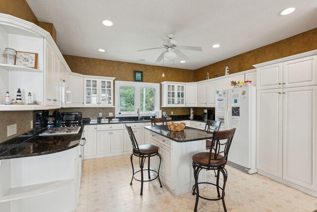 505 E Arctic Ave, Folly Beach, SC 29439 - kitchen with white appliances, open shelves, light floors, a ceiling fan, and recessed lighting