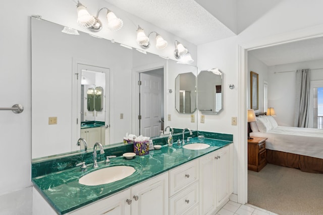 505 E Arctic Ave, Folly Beach, SC 29439 - ensuite bathroom with double vanity and tile patterned flooring