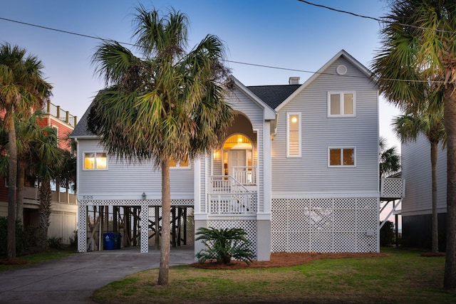 505 E Arctic Ave, Folly Beach, SC 29439 - coastal inspired home with a carport, stairway, concrete driveway, and roof with shingles