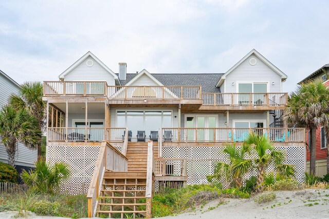 505 E Arctic Ave, Folly Beach, SC 29439 - back of property with a balcony, stairs, a shingled roof, and a chimney
