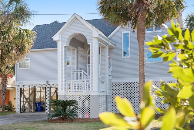 505 E Arctic Ave, Folly Beach, SC 29439 - view of front of house featuring a carport, roof with shingles, and driveway