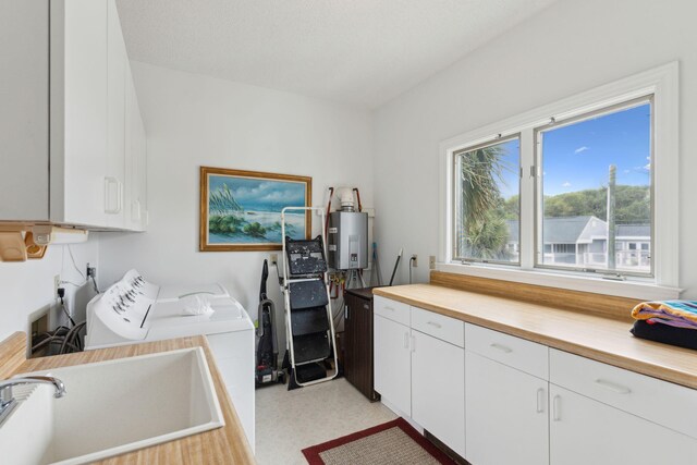 505 E Arctic Ave, Folly Beach, SC 29439 - washroom with cabinet space, water heater, and washing machine and clothes dryer