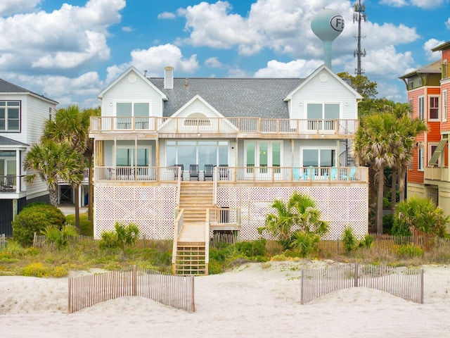 505 E Arctic Ave, Folly Beach, SC 29439 - rear view of property featuring a balcony, stairs, a chimney, and roof with shingles